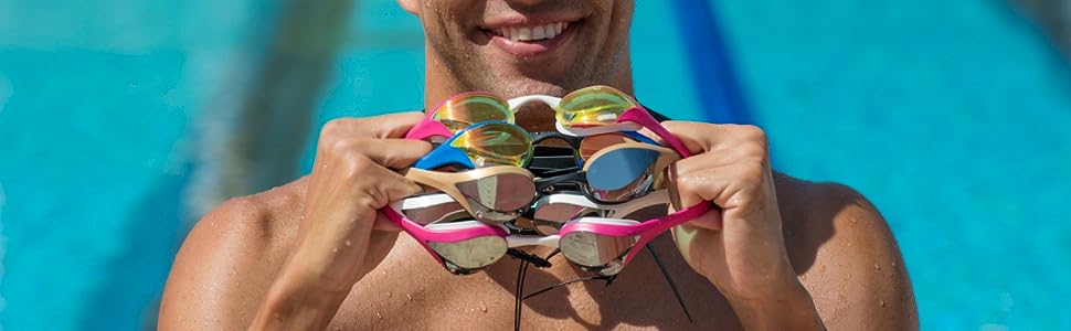 athlete holding arena Cobra Ultra swim goggles for adults in various colors with anti-fog technology