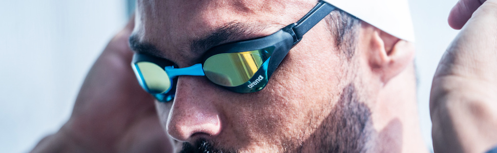athlete wearing arena Cobra Core swim goggles for adults with new swipe anti-fog technology