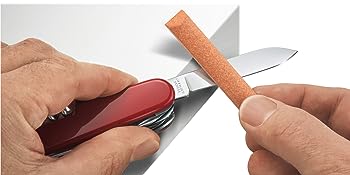SAK Care Tips image of how to sharpen Swiss Army Knife in red with orange stone